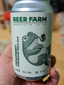 A clearer view of the can of Brookeville Beer Farm Dewpoing, revealing the illustration of a frog at the heart of the label design